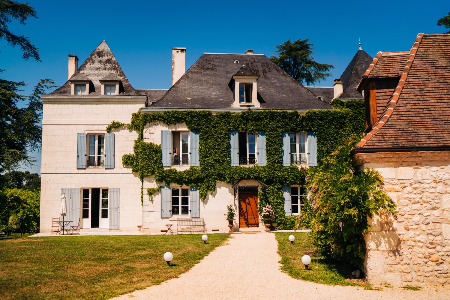 A beautiful mansion covered in vines at Domaine La Fauconnie wedding venue in South France.